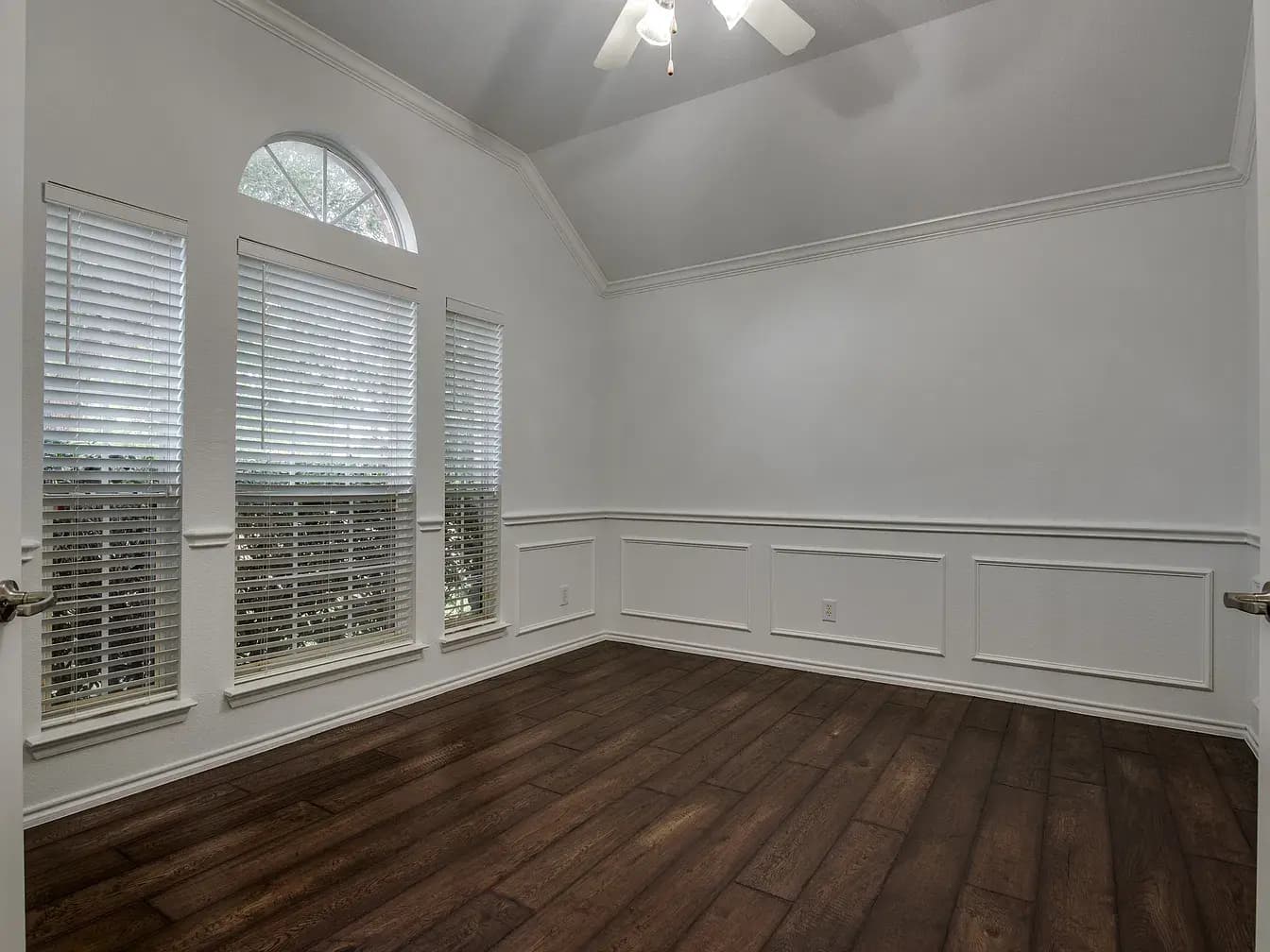 Office or dining room with wainscoting and arched window