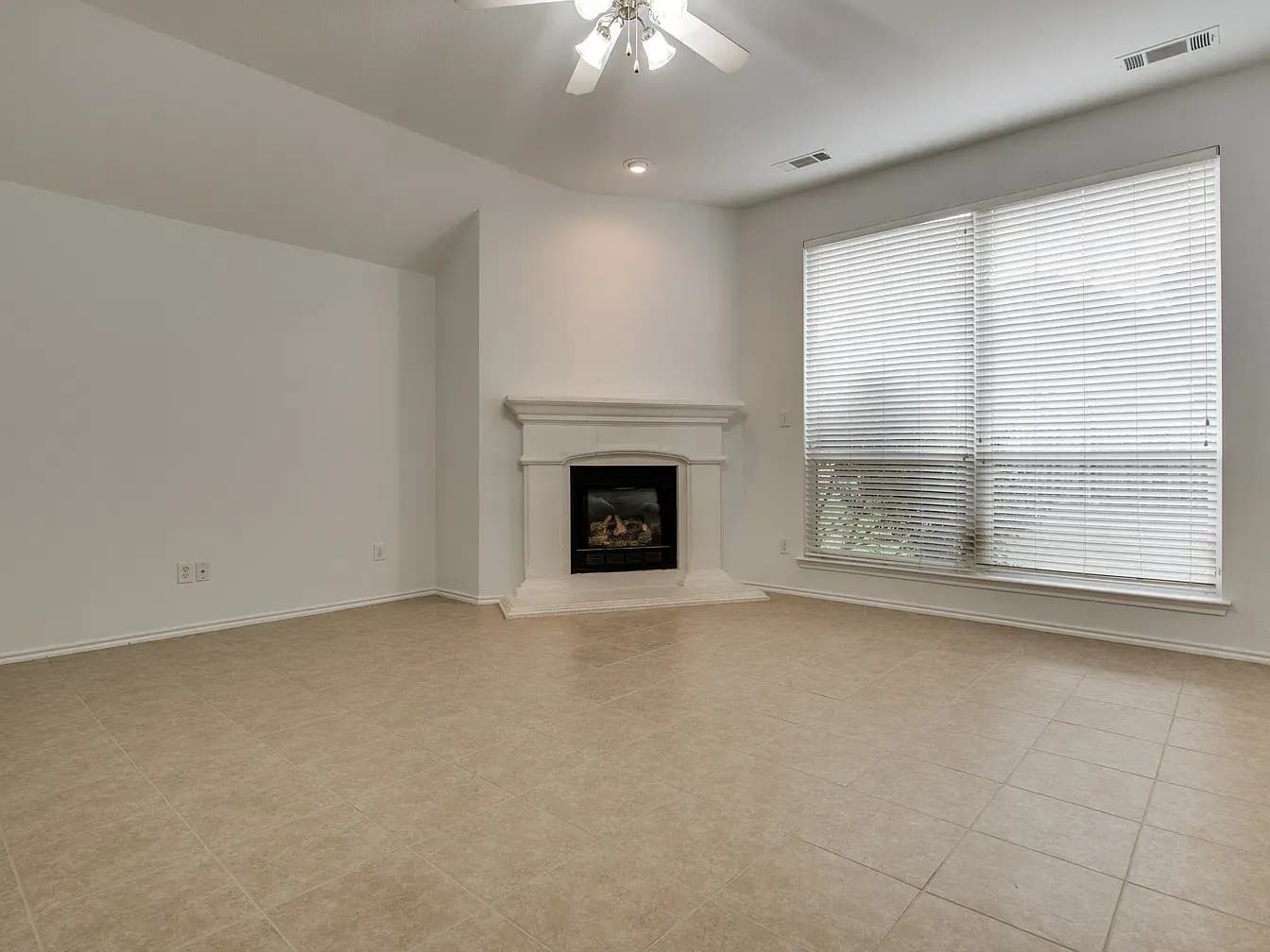 Living room with fireplace and large window
